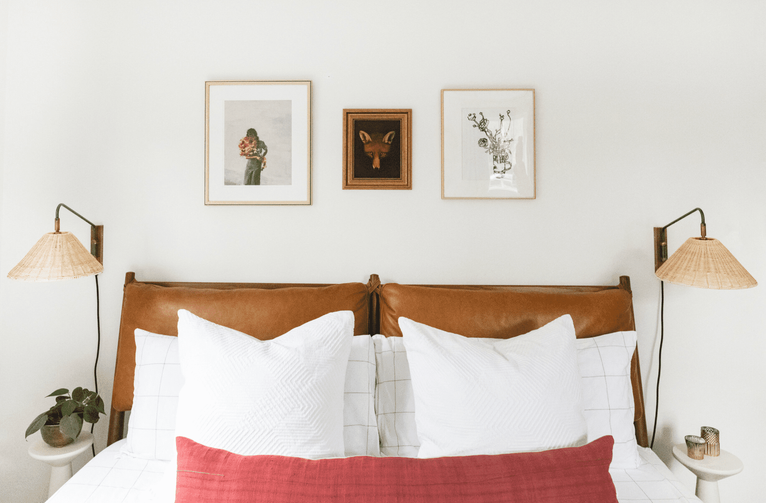 three photos framed above bed